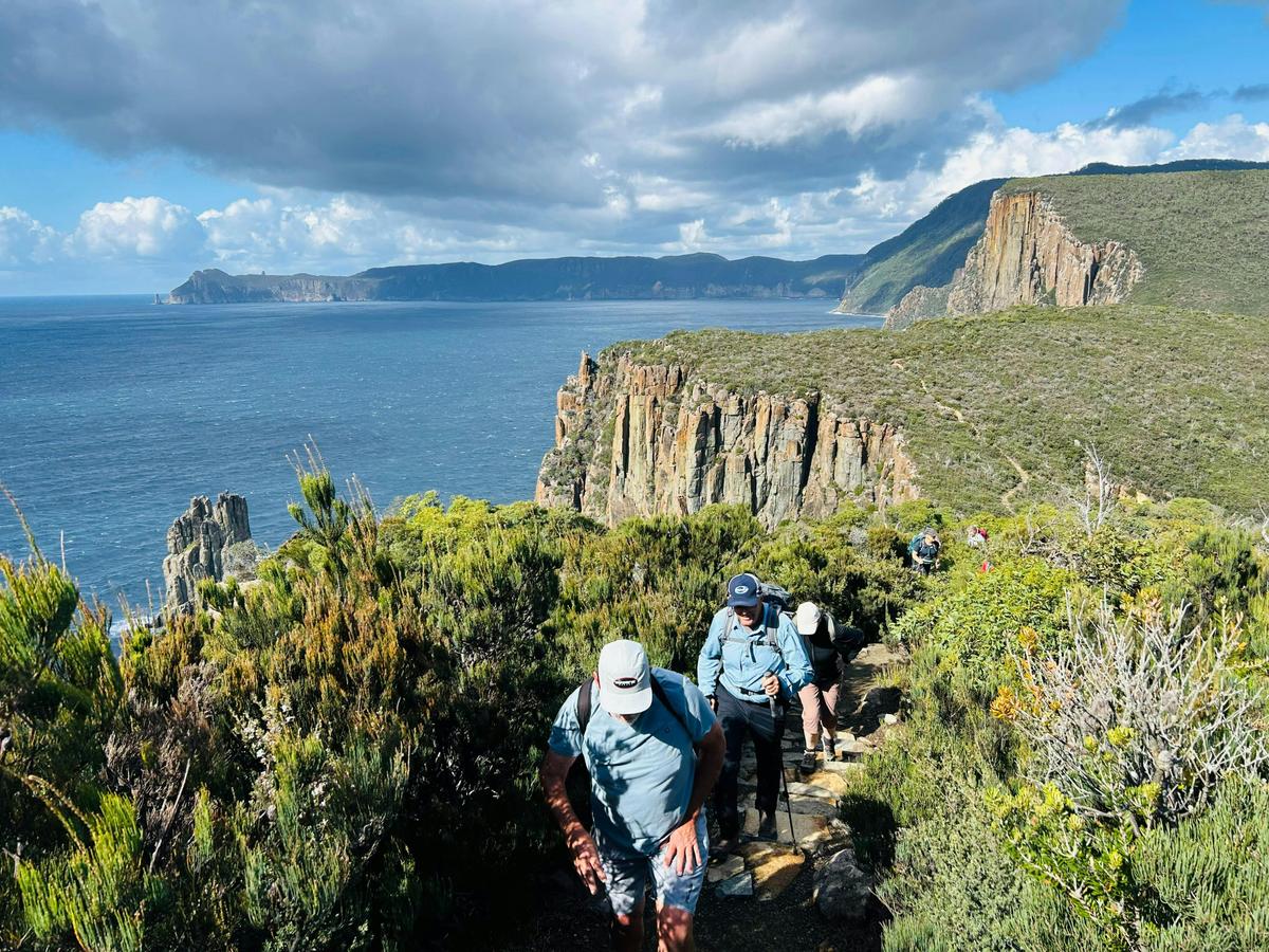 Walking together along the spectacular coastal trails of the Three Capes Walk Tasmania