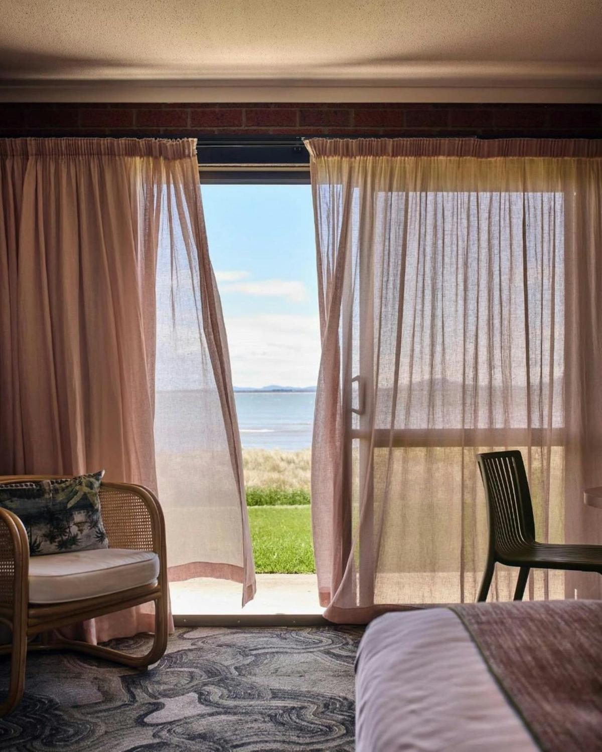 A calm and inviting hotel room with a relaxed coastal vibe.