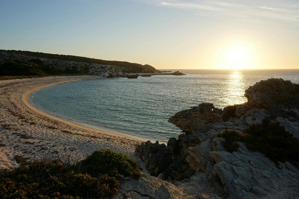 View of large bay with sunset of the water.