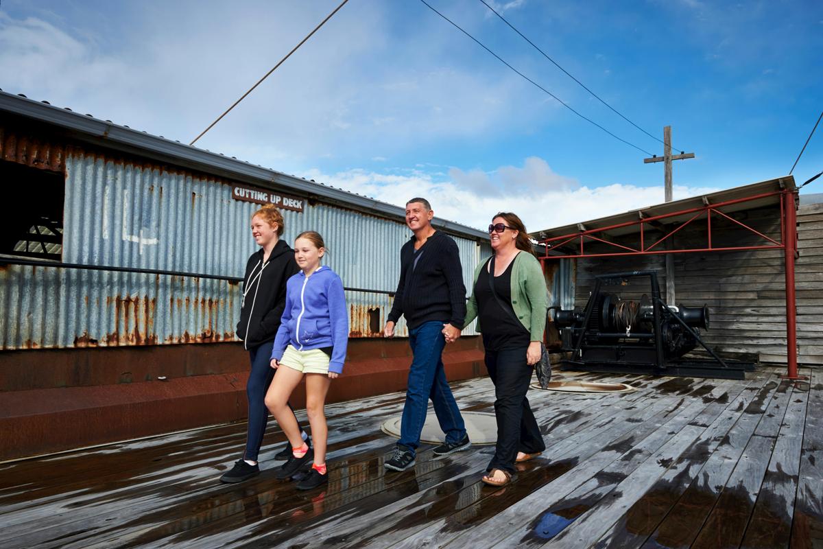 Family walking across cutting up deck