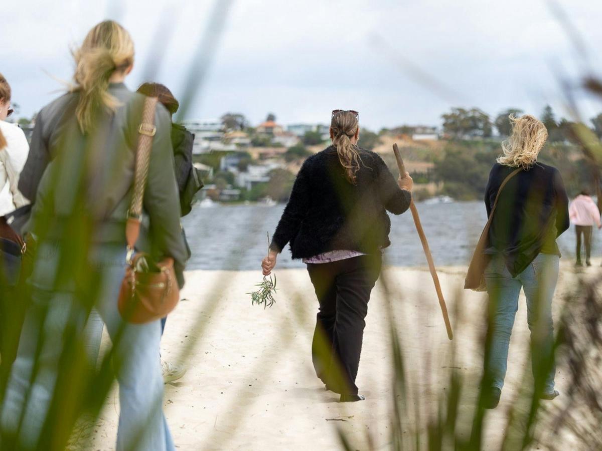 Women walking on the ocean as part of the tour.