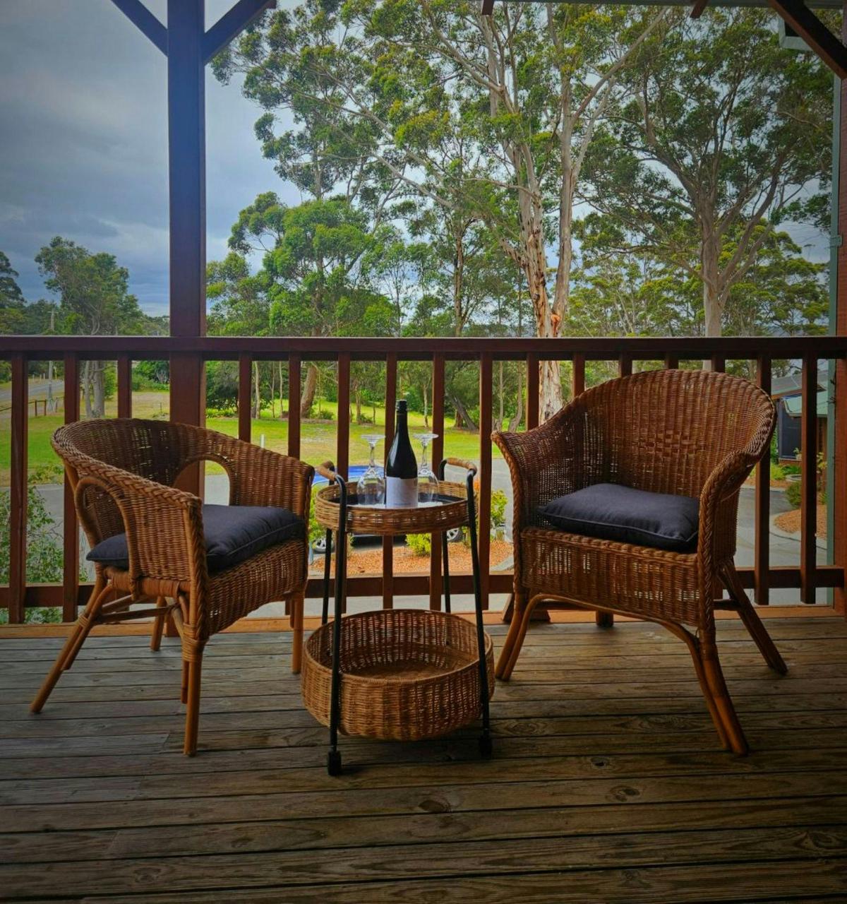 Suite balcony seating with views of Wilson Inlet and surrounding karri trees.