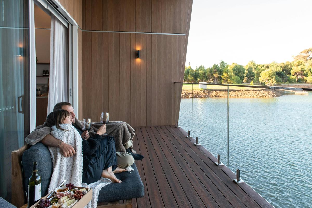 Couple sitting on private lake over the lake.