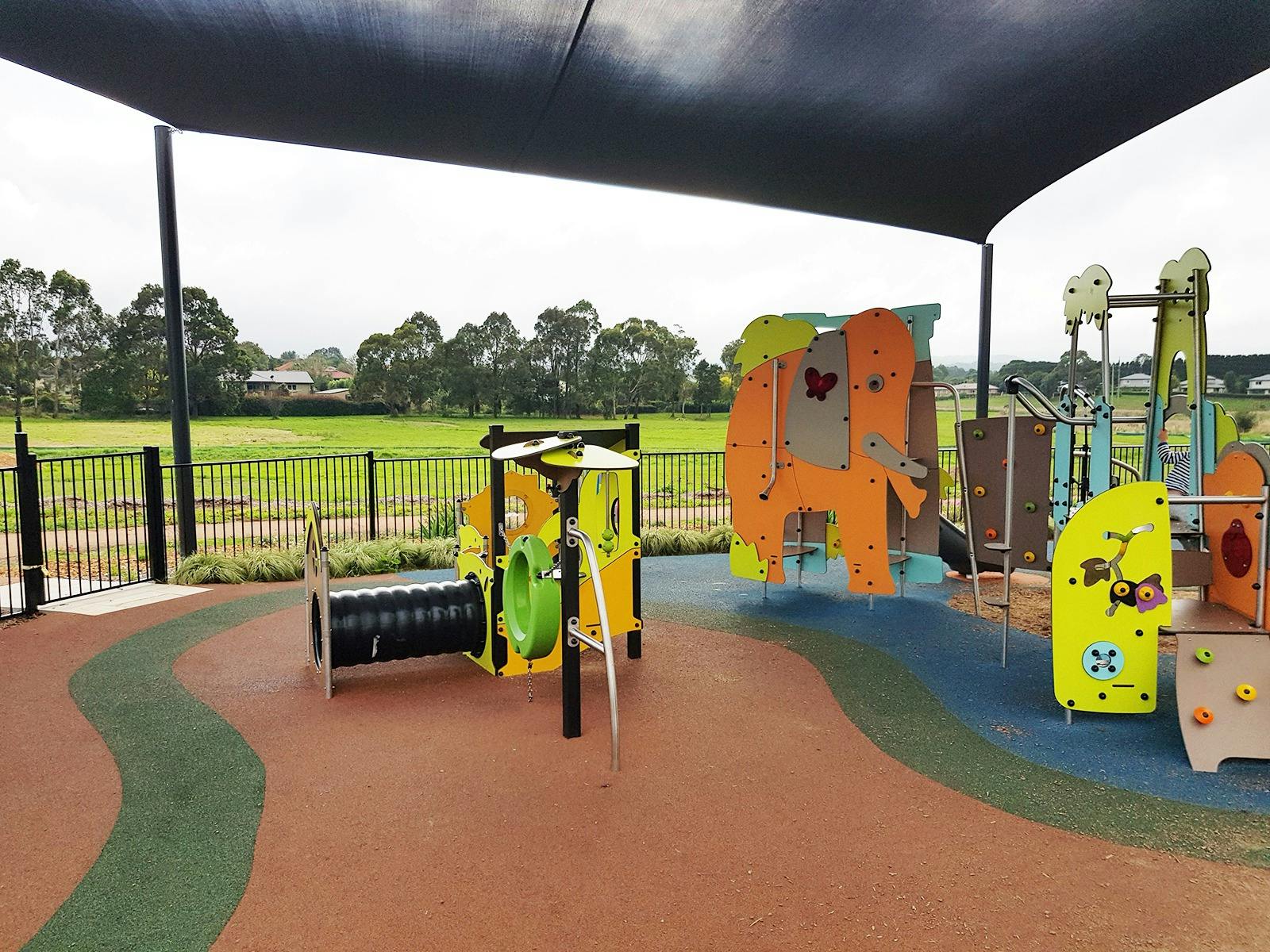 Playground with fencing, shade and picnic setting