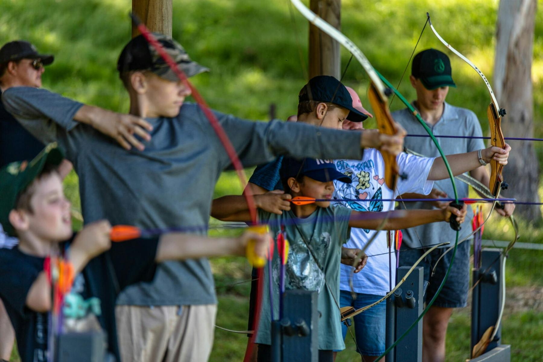 Young people learning archery