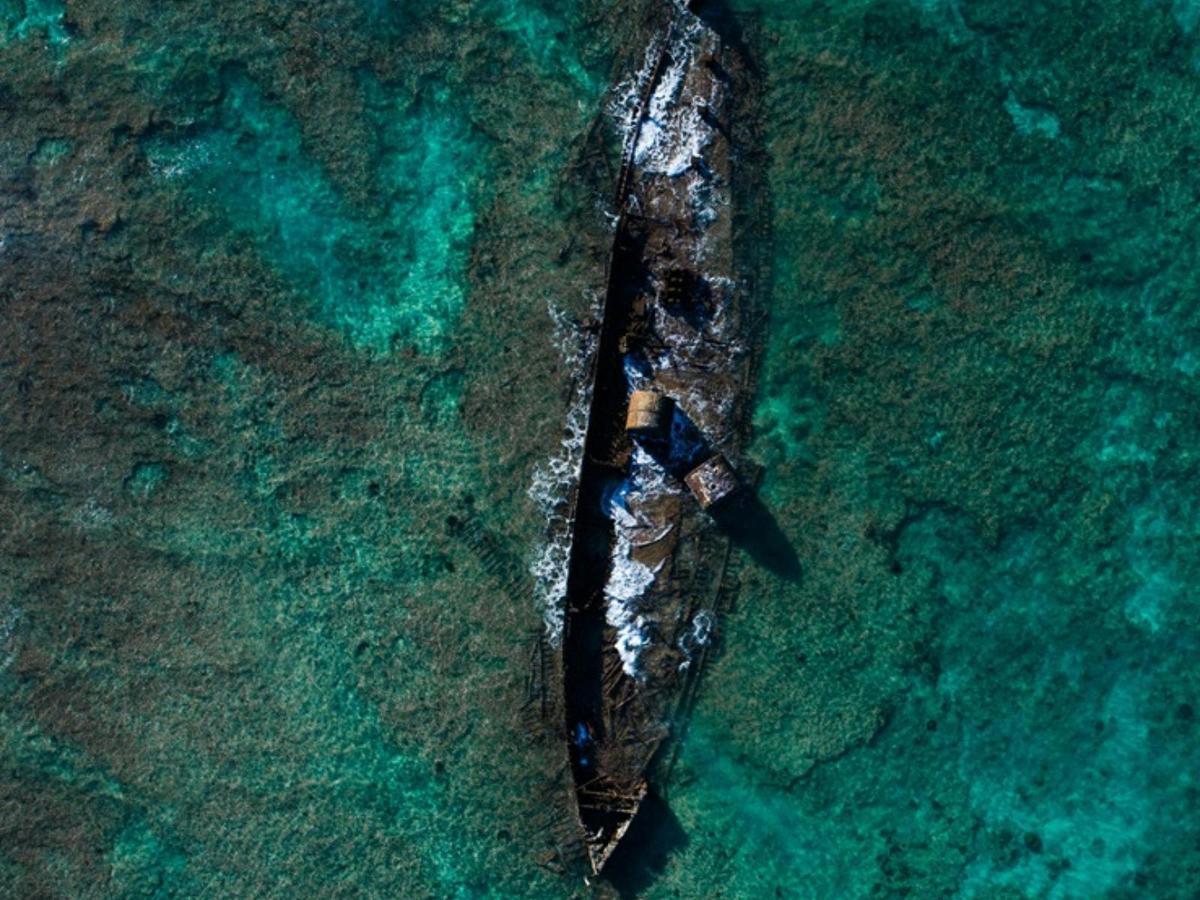 Aerial photo of the SS Mildura cattle shipwreck off Point Murat, resting in shallow reef waters.