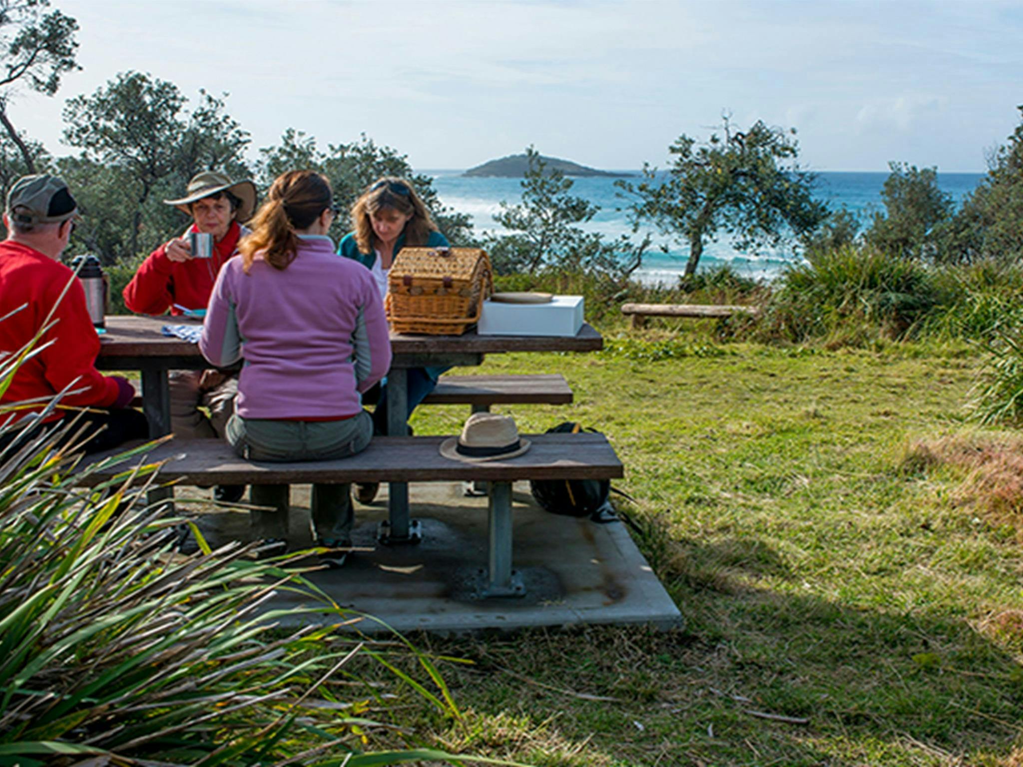 People having lunch at Stokes Island picnic area, Meroo National Park. Photo: Michael van Ewijk/OEH