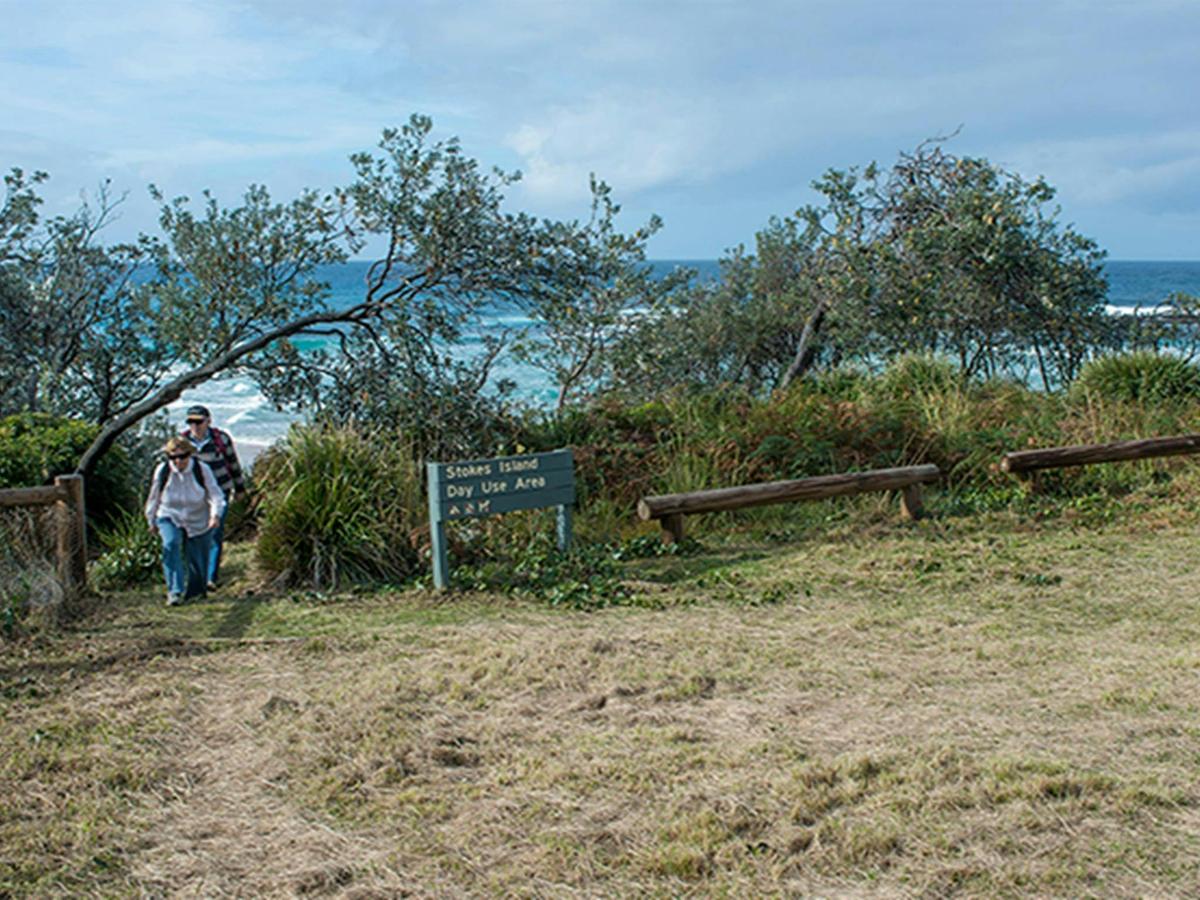 People walking up from the beach at Stokes picnic area, Meroo National Park. Photo: Michael van