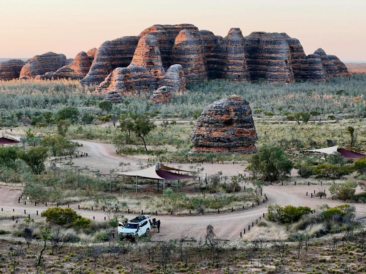 Beehive-shaped rock domes rise above a remote campground and winding dirt roads.