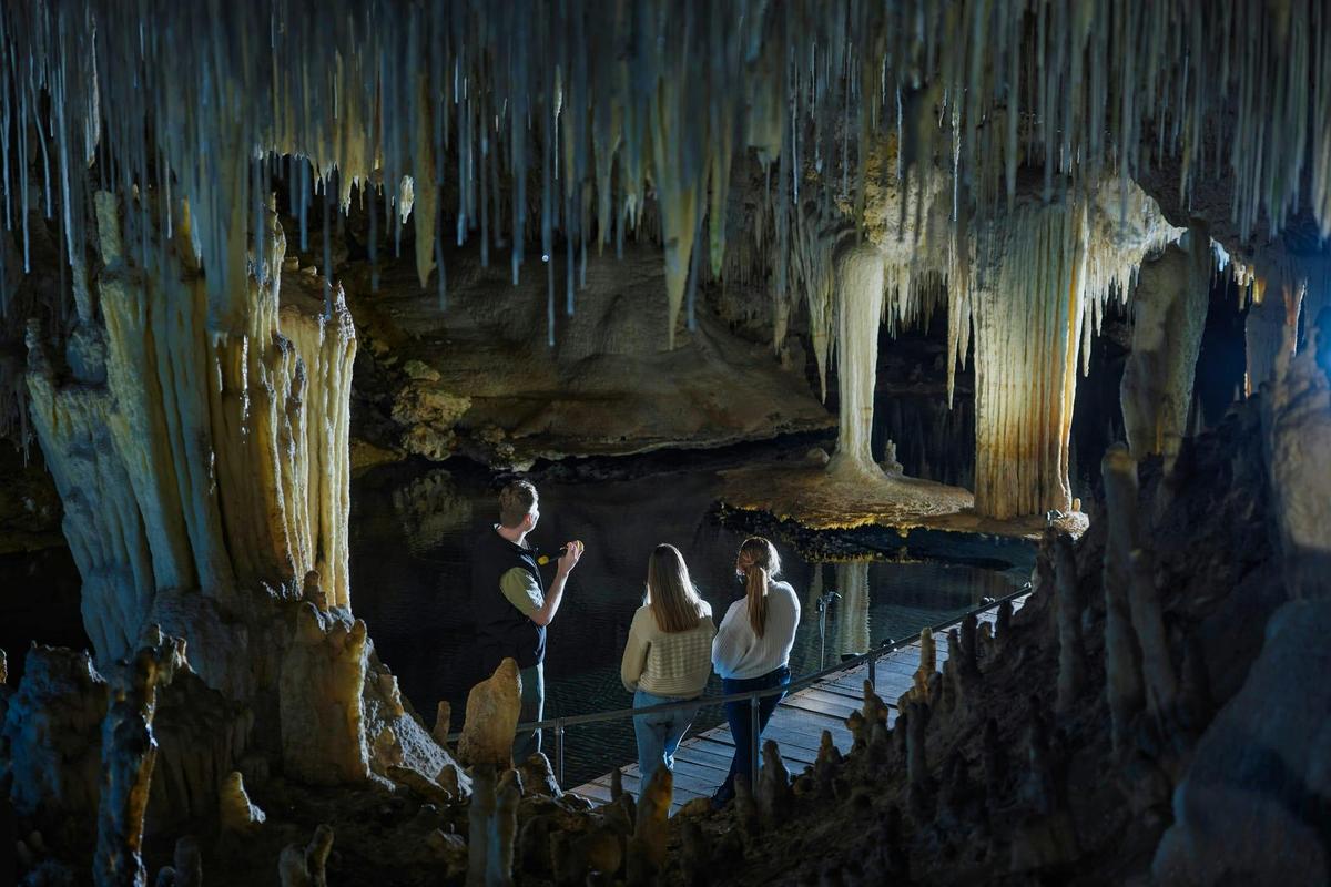 Visitors marvel at the unique 'Suspended Table' formation, which weighs several tonnes.