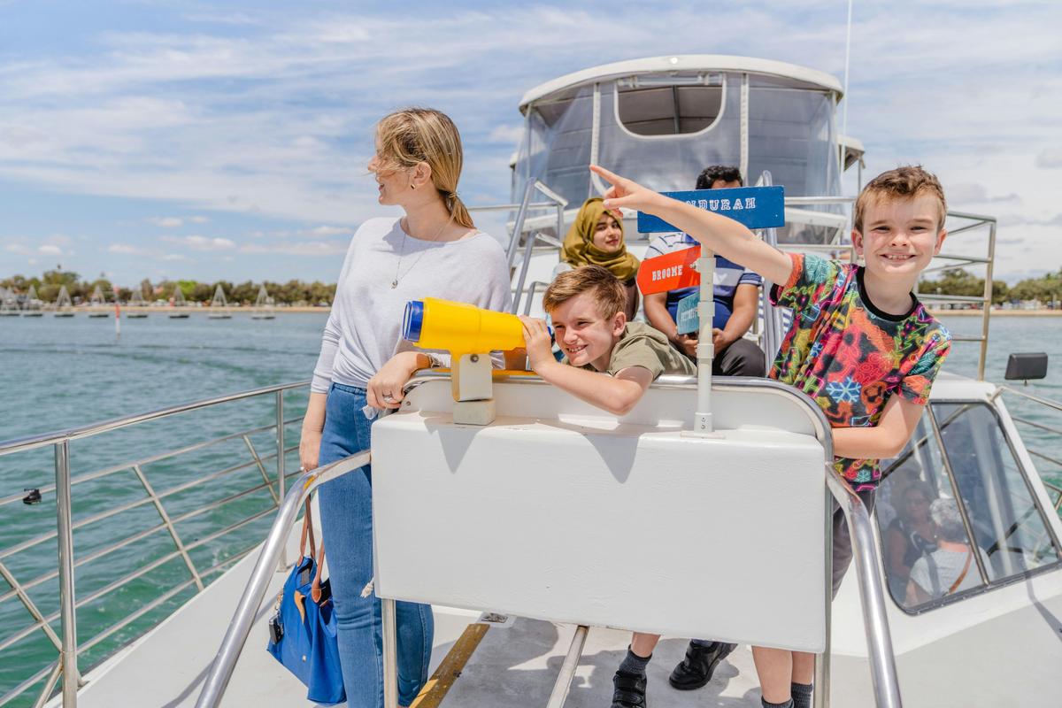 A family spotting dolphins on a Dolphin Cruise & Views