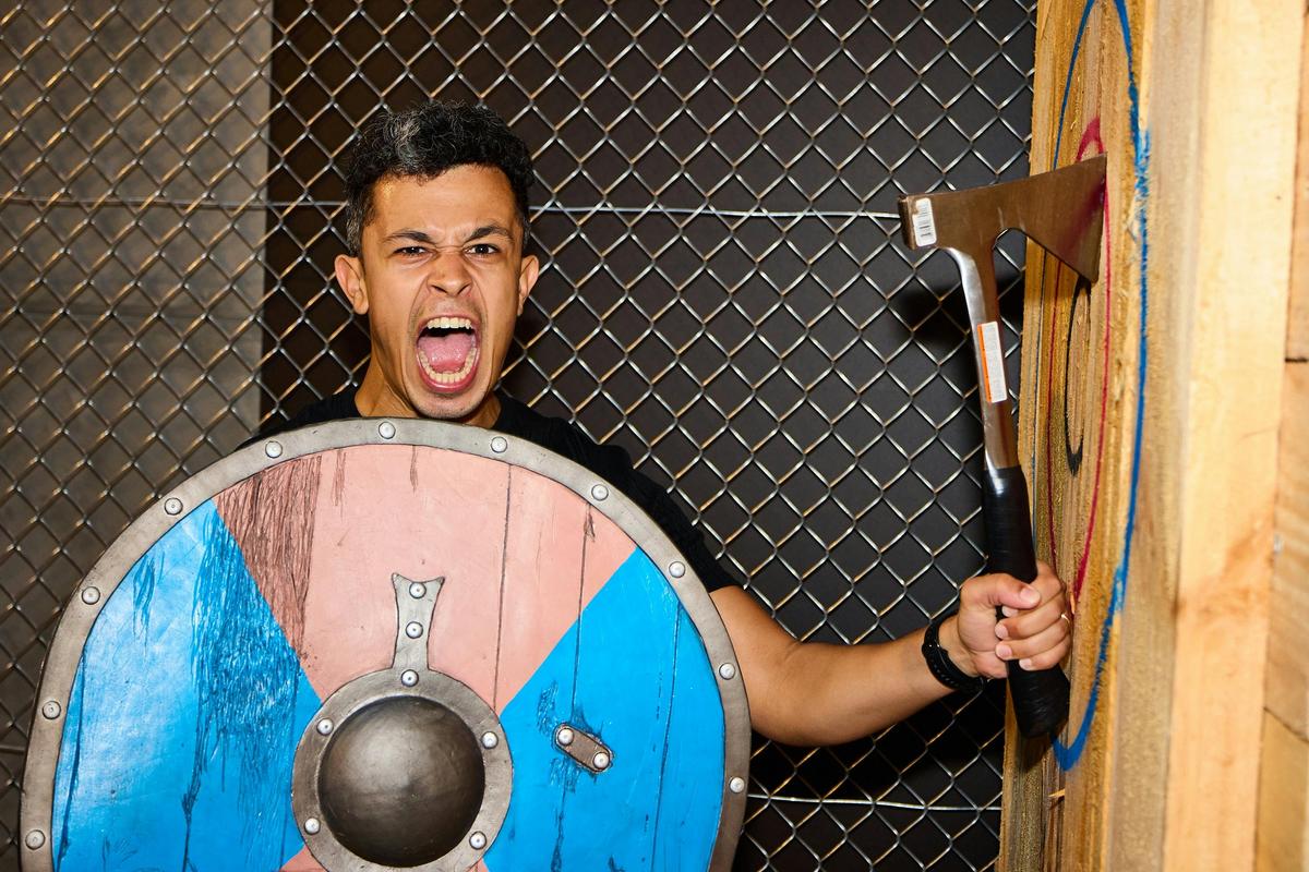 Man holding his axe in the target and a Viking shield
