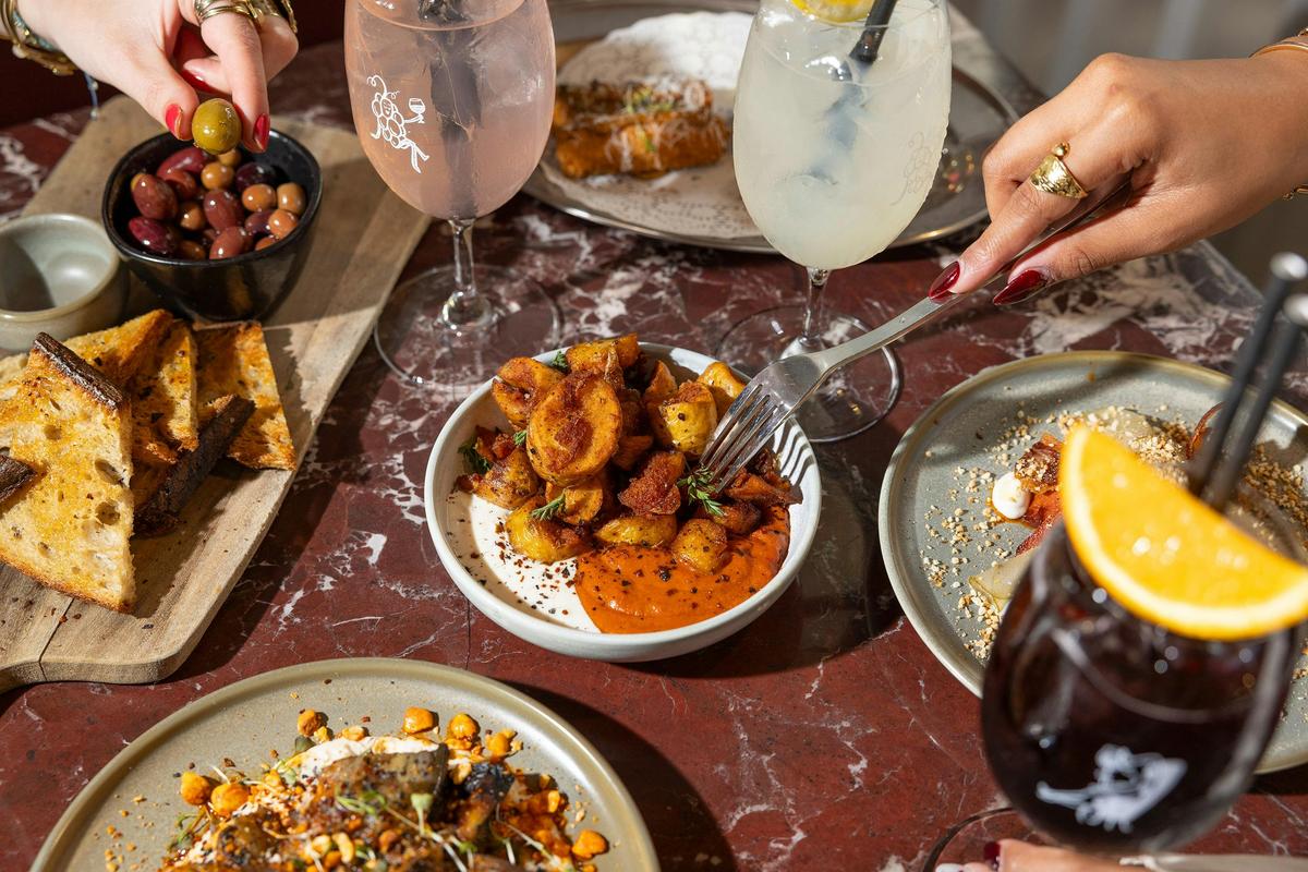 Lums wine bar food picture of olives, wine cocktails and potatoes.