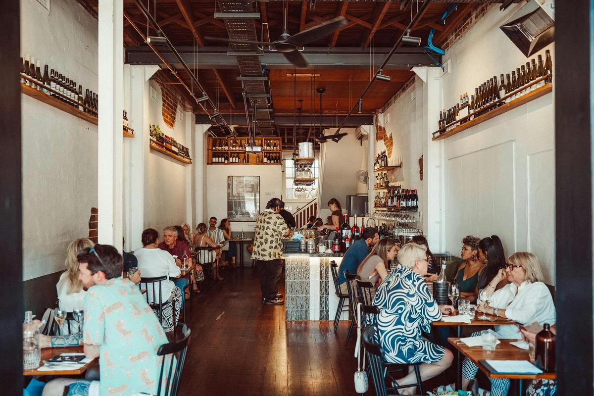 Lums wine bar internal photo with people enjoying great food and drinks.