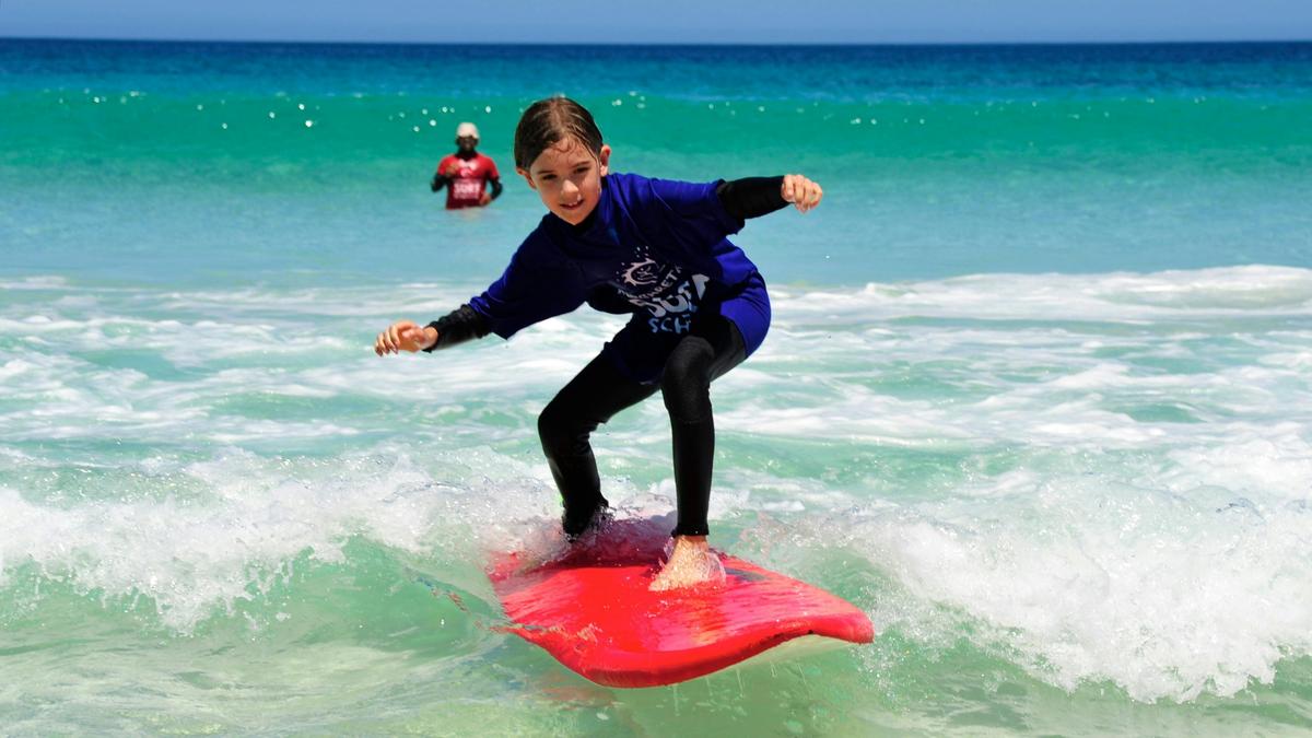 Child learning to surf