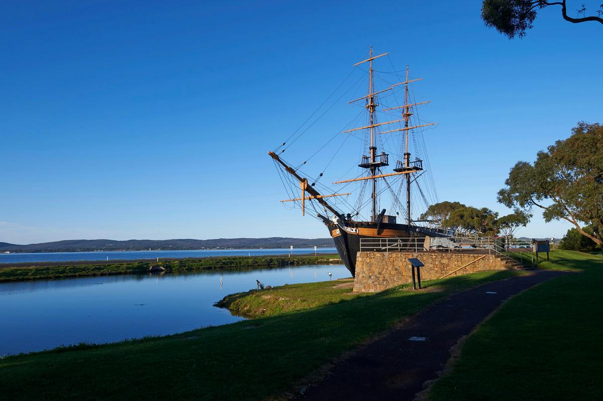 a replica ship near a pool of water