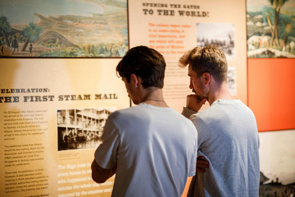 two people looking at a display with text and images