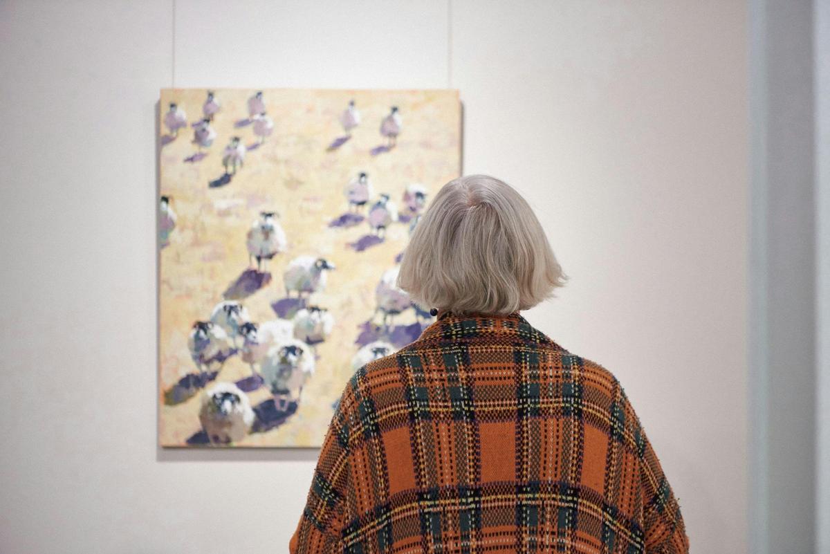 Visitor viewing Alastair Taylor's Eight percent, part of Sheep Show at Mundaring Arts Centre