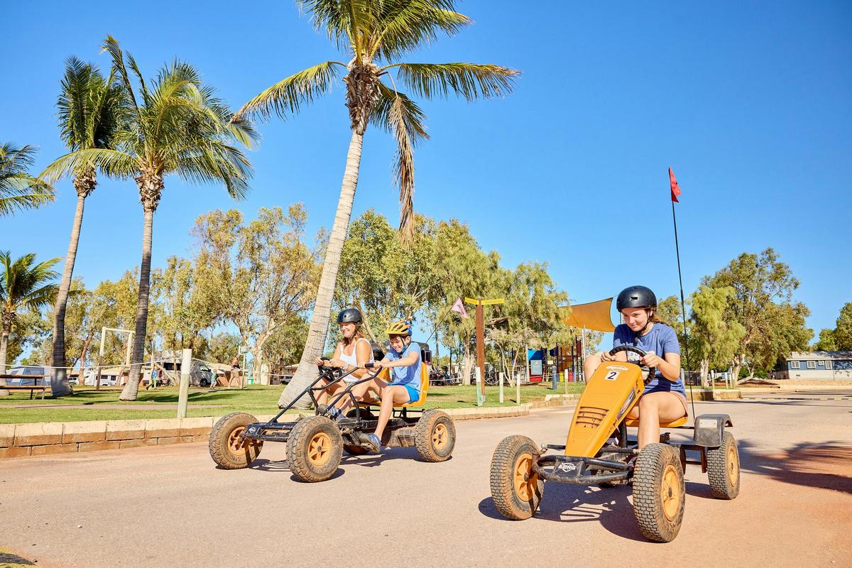 Kids riding go karts in holiday park