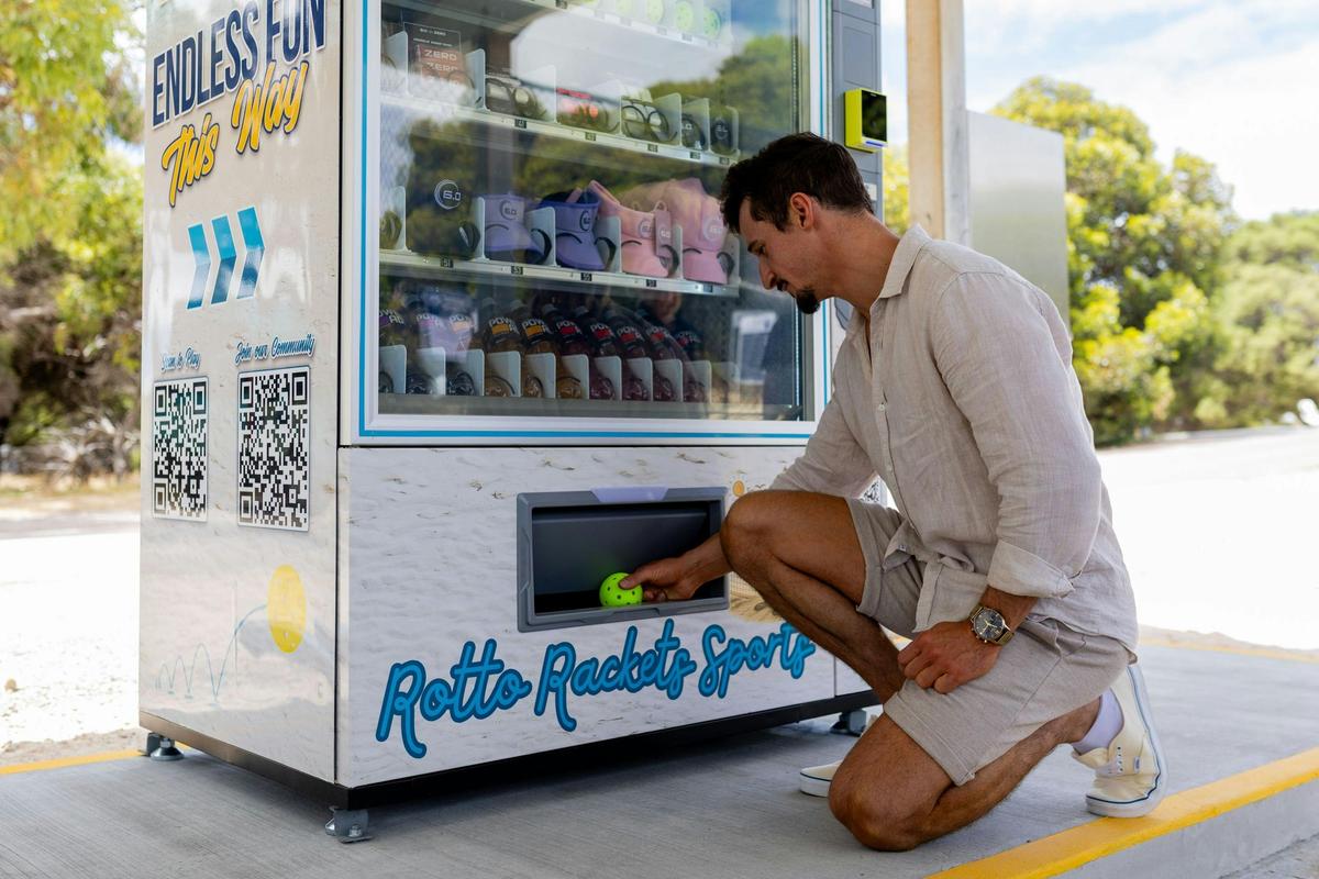 Self-service vending machine at Rotto Rackets Sports with pickleball equipment and refreshments avai