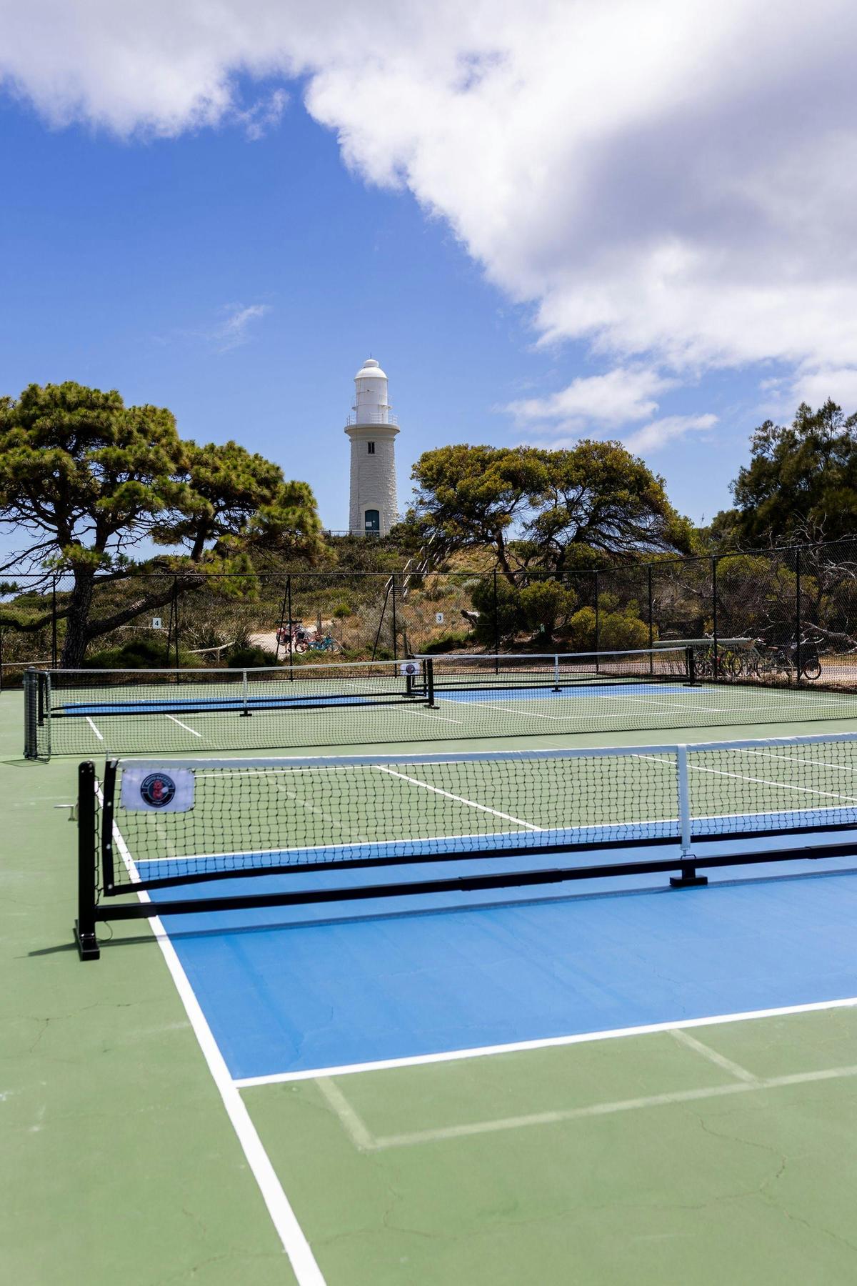 Pickleball courts at Bathurst Point with Bathurst Lighthouse in the background on Wadjemup / Rottnes