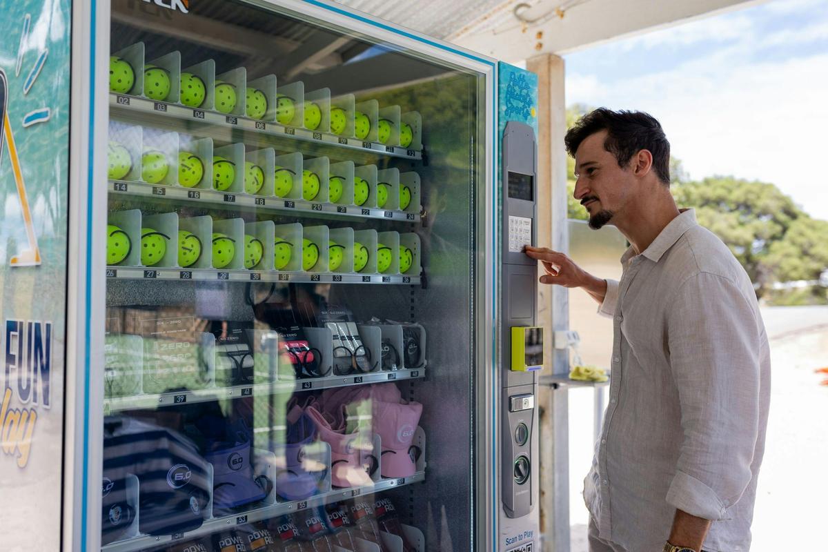 Courtside vending machine with pickleball equipment and refreshments at Rotto Rackets Sports.