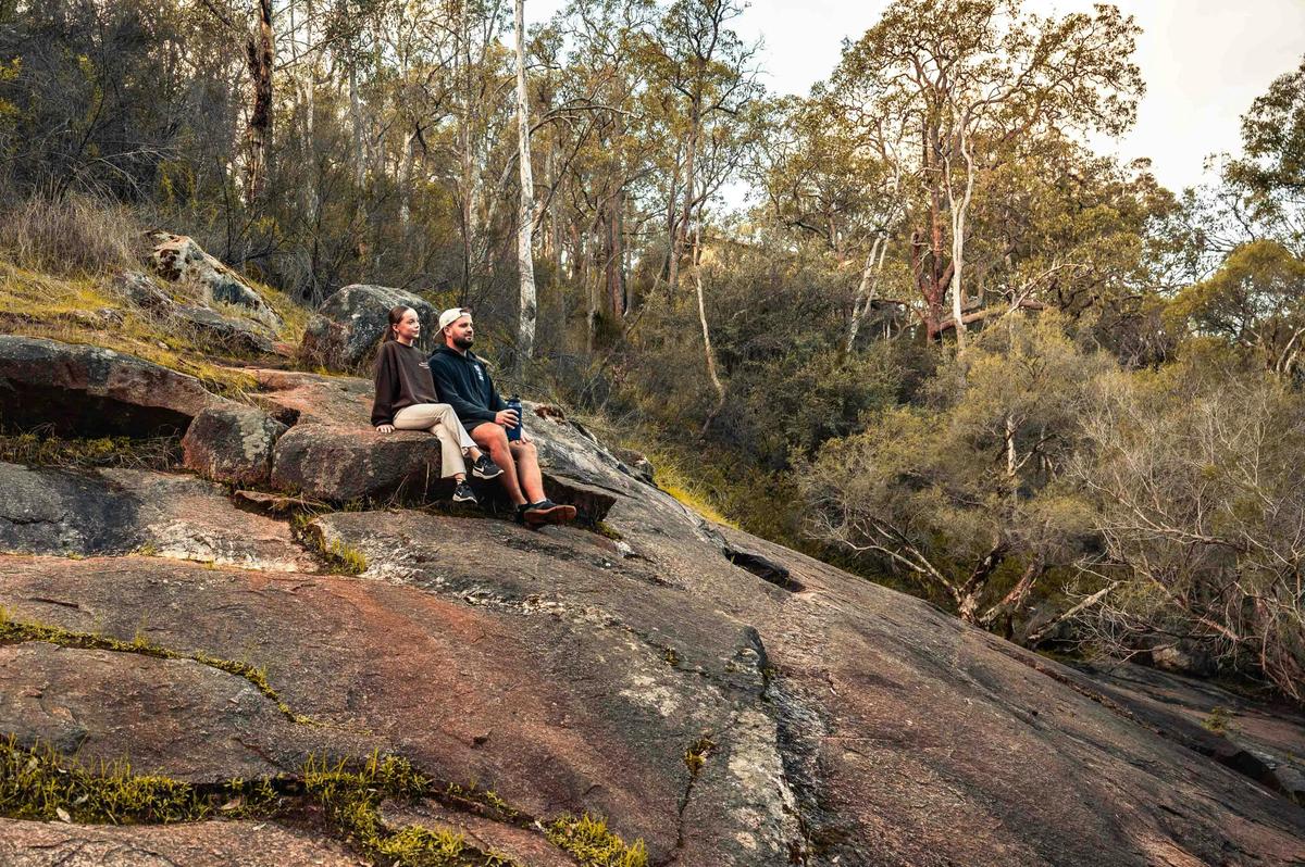 Man and girl. sitting on rocks