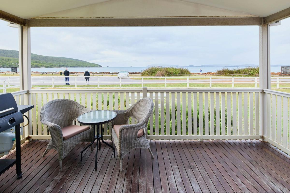 Chairs and table on cabin deck overlooking the ocean
