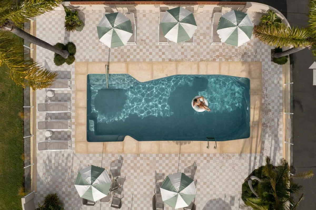 Heated pool with umbrellas, sunloungers and seating