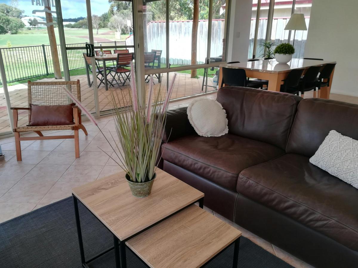 Big living area with comfortable leather couches and golf views