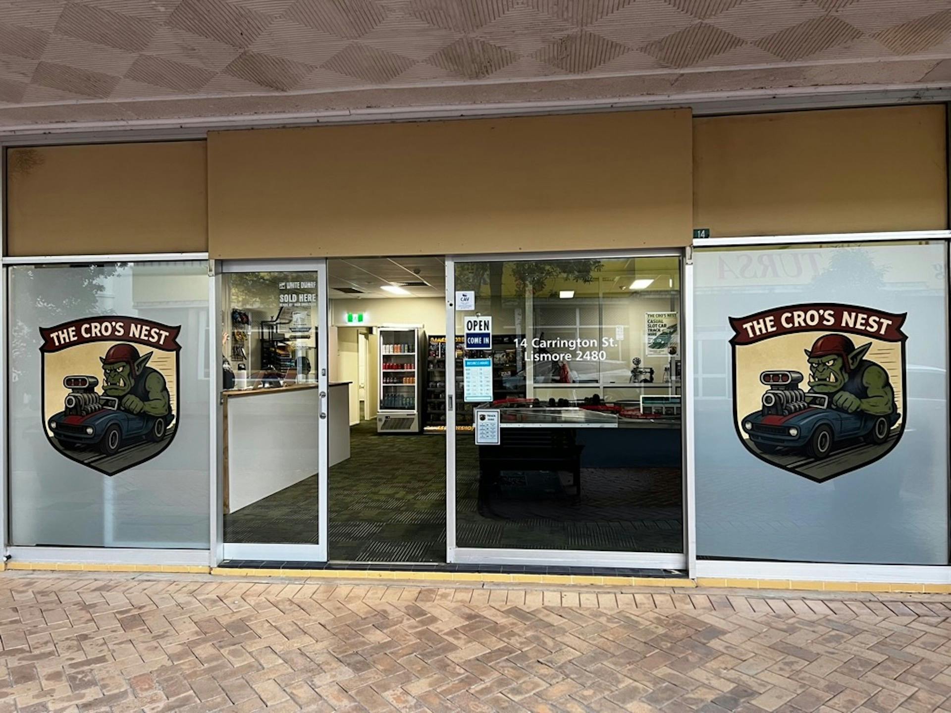 Front entrance of The Cro’s Nest with logo decals and shop interior visible.