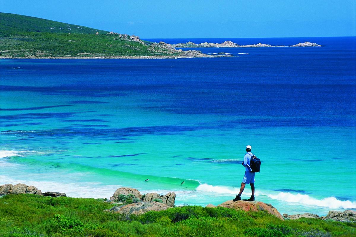 Hiker overlooking surfing action at Smiths Beach, on the Leeuwin - Naturaliste Cape to Cape Walk