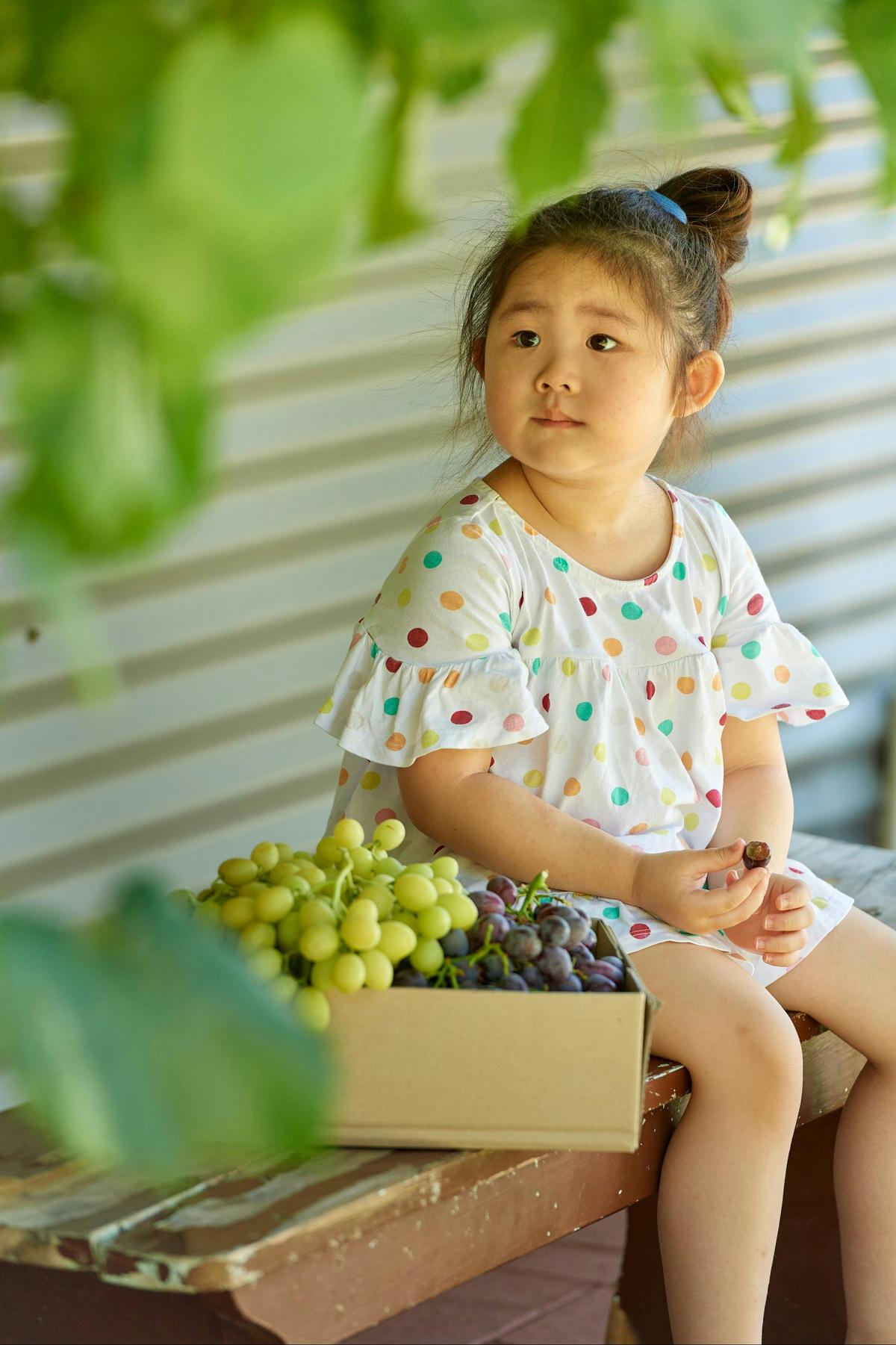 Girl eating grapes