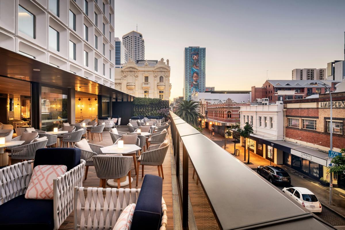 A terrace view overlooking a city at sunset