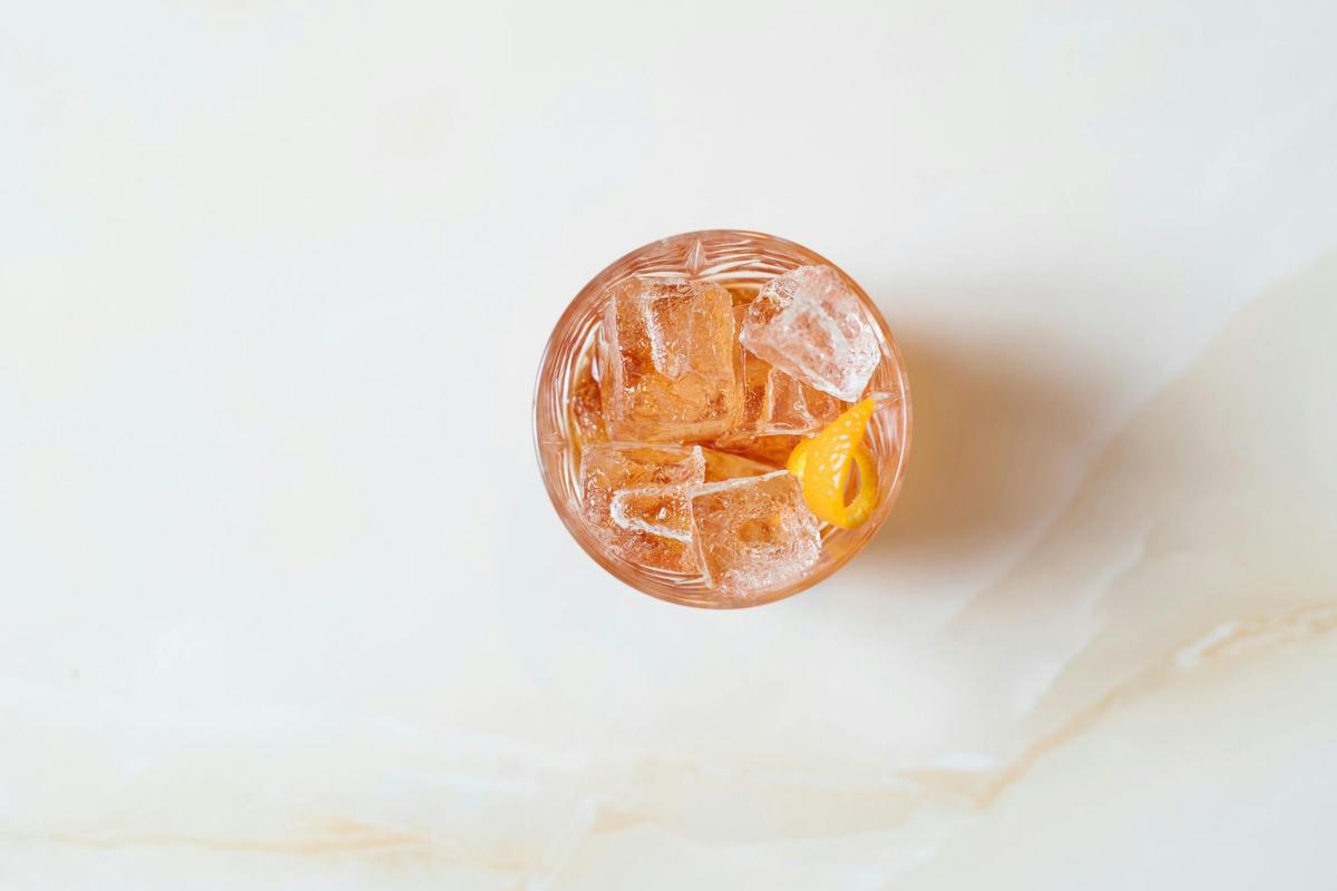 A cocktail sitting on a marble table