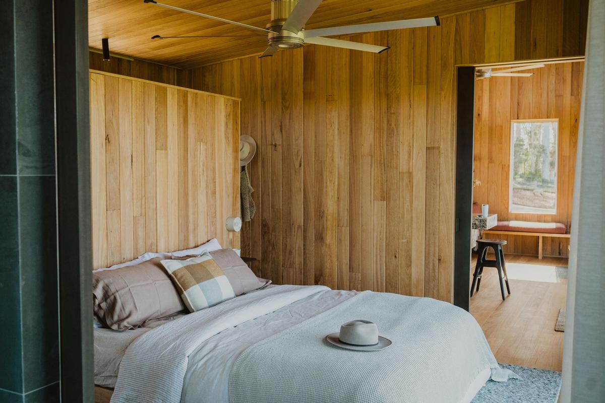 King bed draped in french linen in Cabin Wren