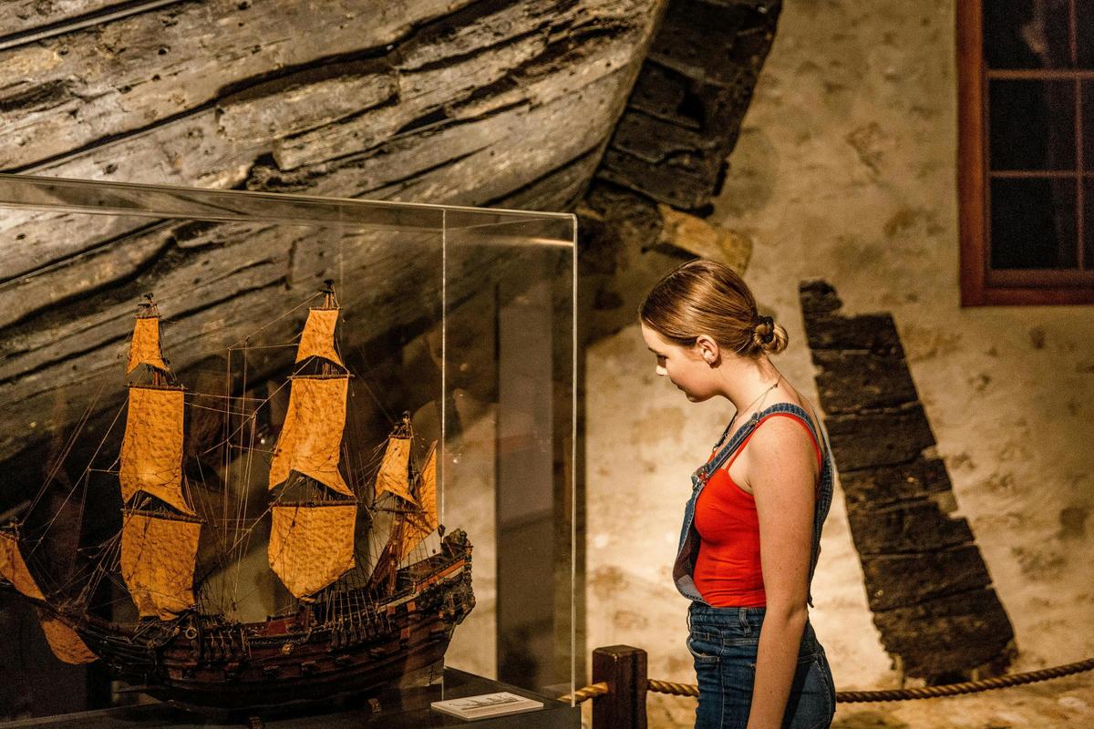 a person looks at a model ship