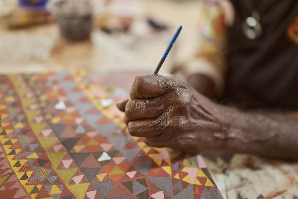 Artist Ben Ward painting at Waringarri Arts