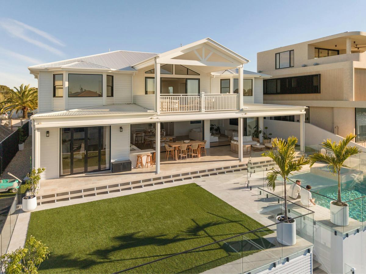 The canal-side elevation: heated pool, raised spa, covered alfresco and lawn