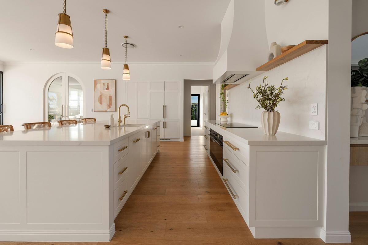 Kitchen, long stone island and arched doorway