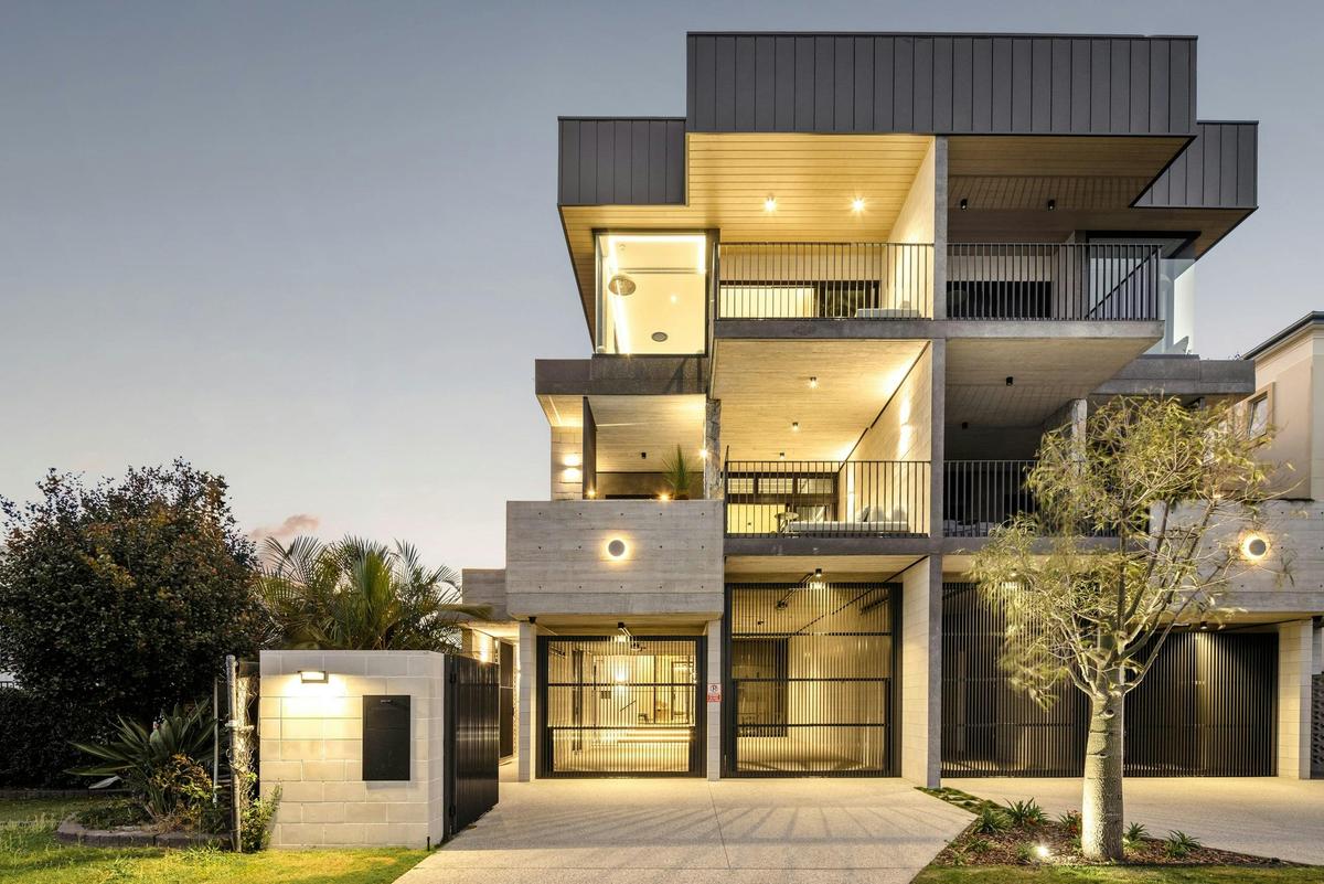 The residence at twilight, 3 levels lit from within above the garaging