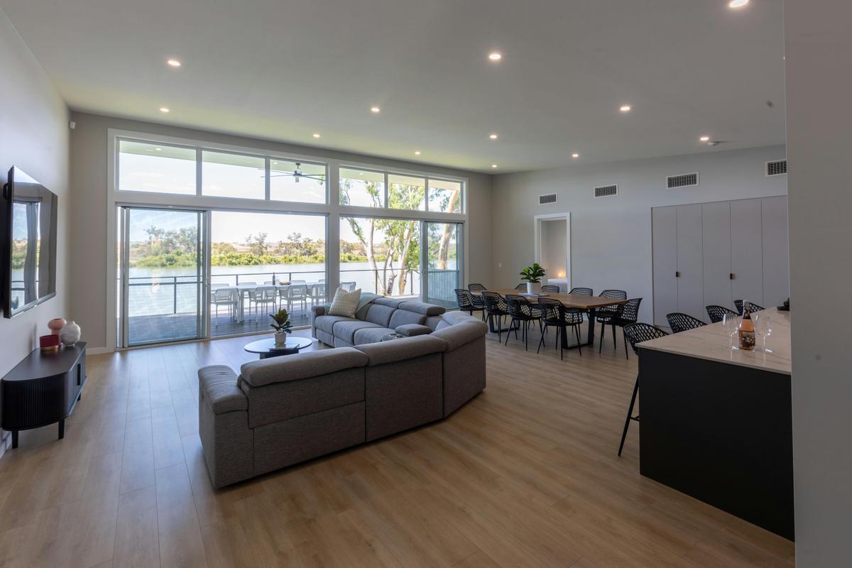 large lounge and dining area leading out to a balcony
