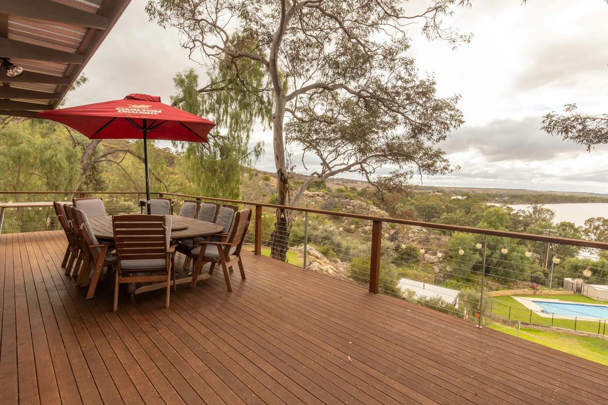 Balcony views over the pool, tennis courts and river