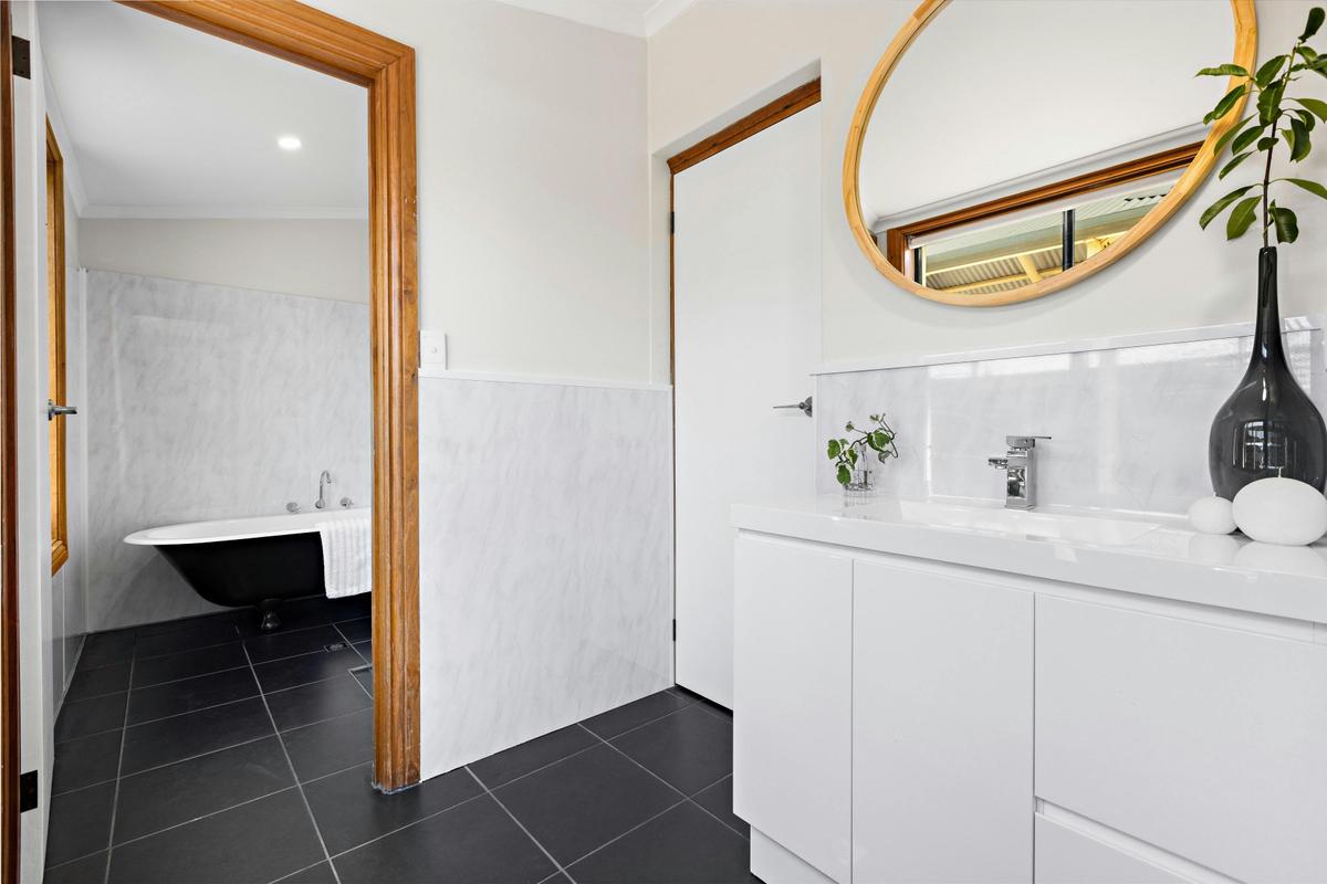Downstairs accommodation is serviced by a self-contained bathroom with antique claw-foot bathtub.