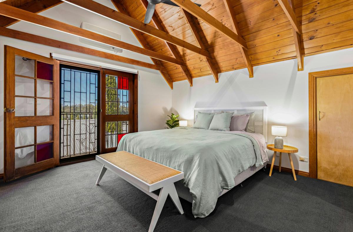 The spacious upstairs master features an ensuite bathroom and Juliet balcony with vineyard views.