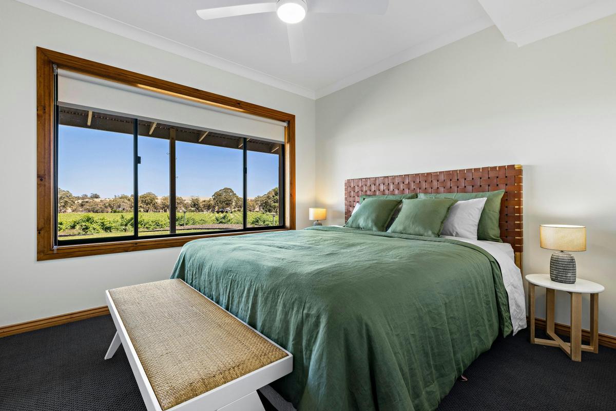 The downstairs master offers stunning vineyard views and a king-size bed.
