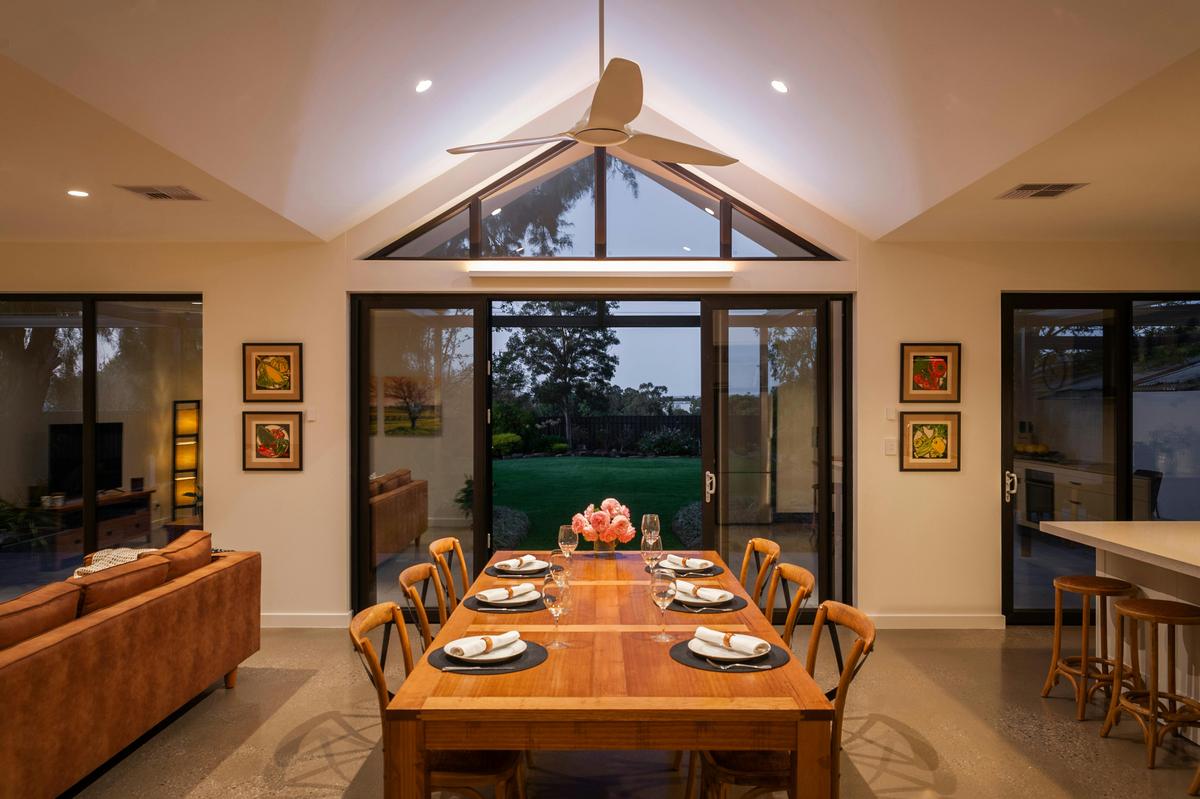 Fabulous dining area with gable ceiling overhead fan and distant views