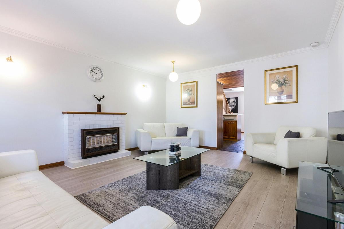 Lounge room with comfortable lounge, TV and fireplace