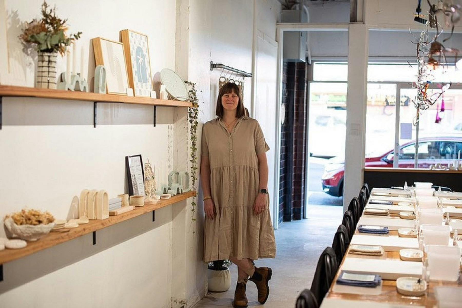 Victoria in her shop showcasing beautiful local art creations