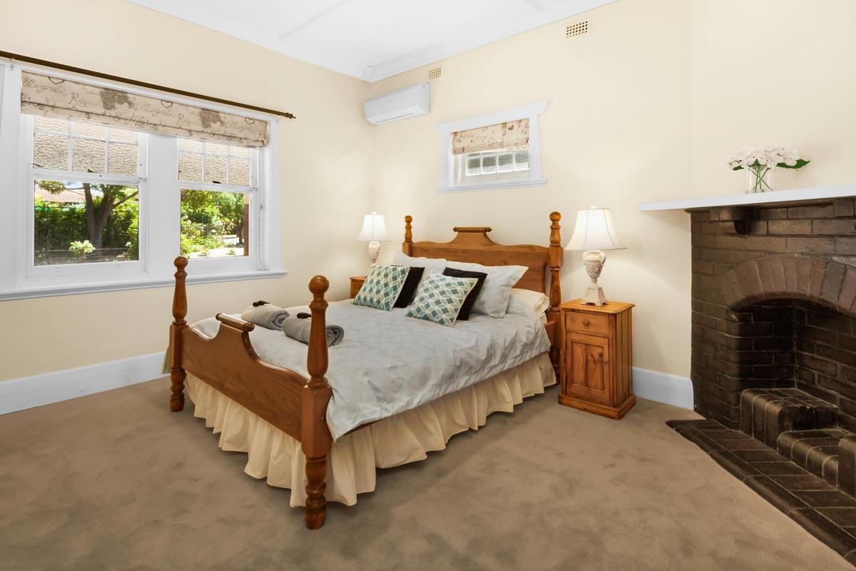 Main bedroom with comfortable queen size poster bed